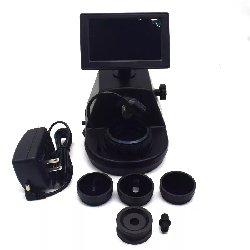 The complete JYBS digital diamond inscription viewer kit arranged flat with its multi-stage adapters and power cable. The complete JYBS digital diamond inscription viewer kit arranged flat with its multi-stage adapters and power cable.