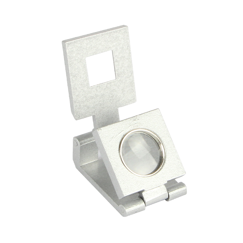 An angled top view of the Alfa Mirage linen tester loupe partially folded, showcasing the optical single lens. An angled top view of the Alfa Mirage linen tester loupe partially folded, showcasing the optical single lens.