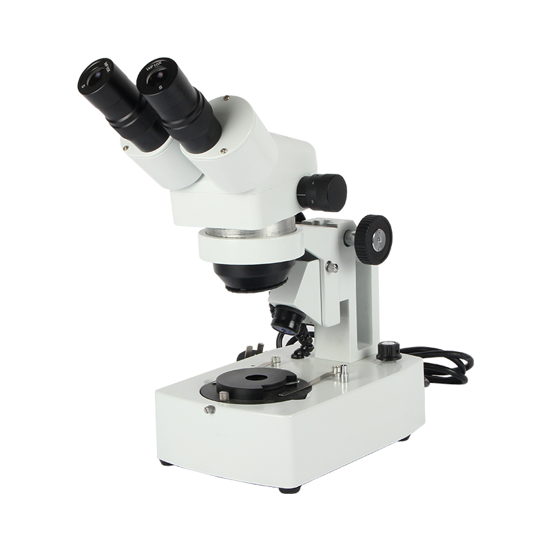 Front left profile of the white JYBS gem microscope showcasing the continuous zoom adjustment knobs and coarse focus track wheels. Front left profile of the white JYBS gem microscope showcasing the continuous zoom adjustment knobs and coarse focus track wheels.