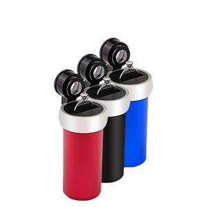 Three variants of the JYBS diamond inscription loupe in red, black, and blue finishes, each holding a silver engagement ring on its platform stage.