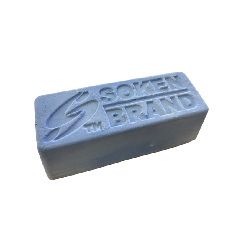 A single bar of Soken Brand blue polishing compound is shown at an angle on a white background. A single bar of Soken Brand blue polishing compound is shown at an angle on a white background.
