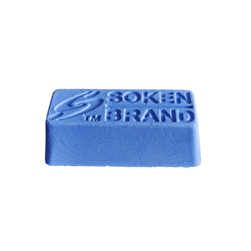 A single bar of blue Soken Brand polishing compound, showing the embossed logo on a white background. A single bar of blue Soken Brand polishing compound, showing the embossed logo on a white background.