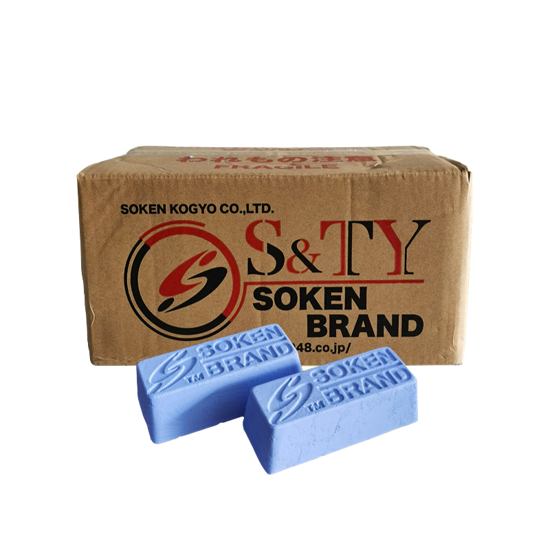 Two bars of Soken blue polishing compound in front of a branded cardboard box. Two bars of Soken blue polishing compound in front of a branded cardboard box.