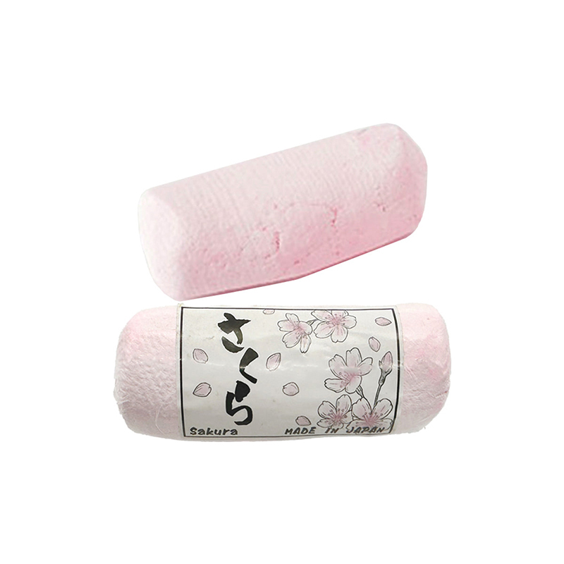 Two pink cylindrical Alfa Mirage® SAKURA Polishing Compounds, wrapped, showing "Sakura MADE IN JAPAN" labels. Two pink cylindrical Alfa Mirage® SAKURA Polishing Compounds, wrapped, showing "Sakura MADE IN JAPAN" labels.