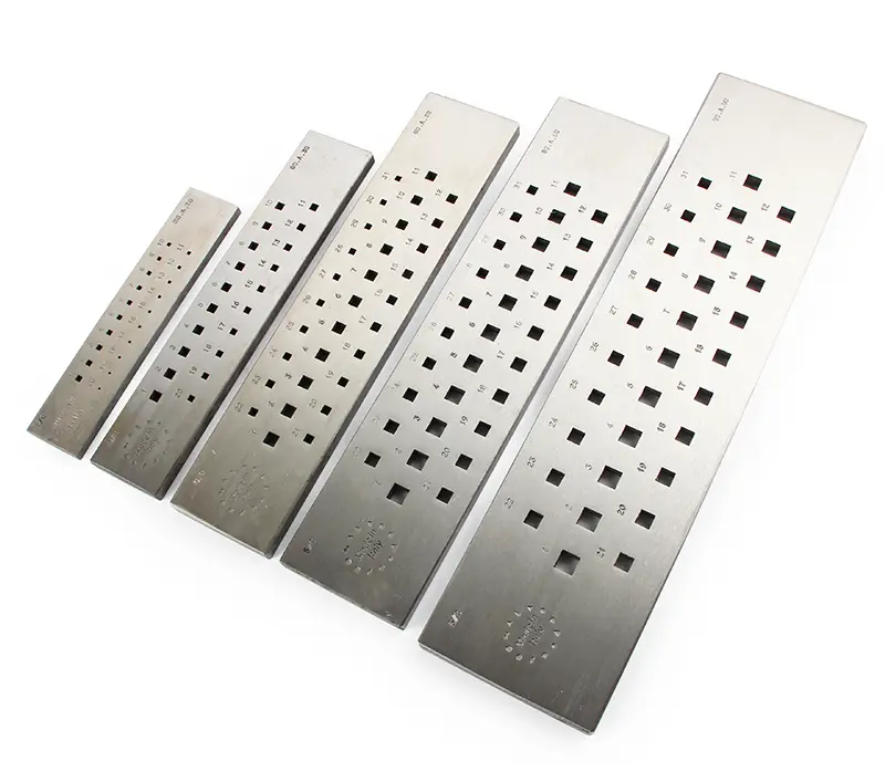 A set of five Italian-made rectangular tungsten carbide draw plates with various square hole sizes for jewelry making.