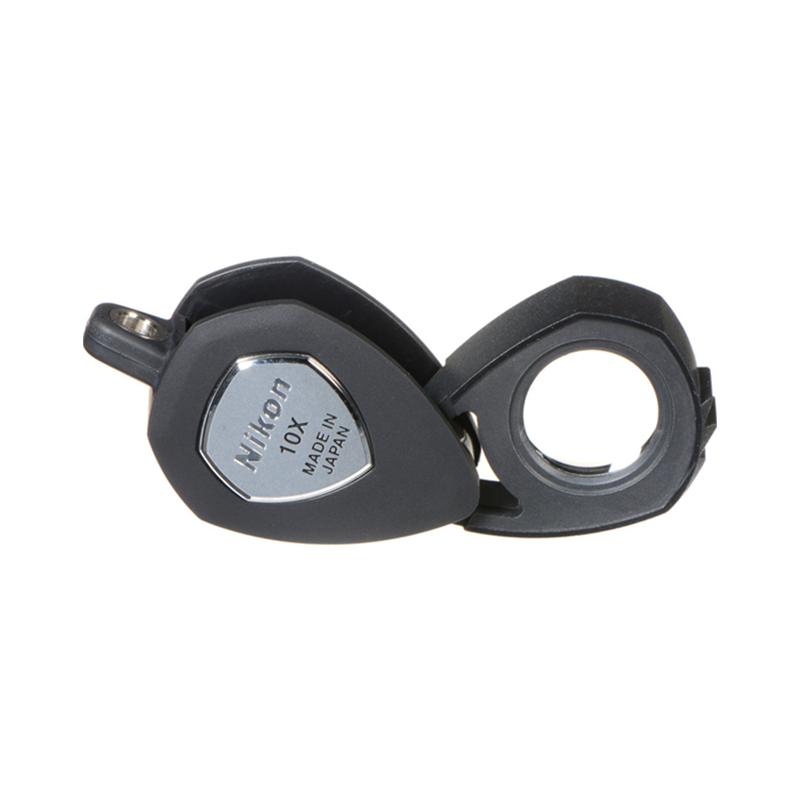 Nikon 10x triplet loupe for jewelry inspection, featuring a compact black folding design, made in Japan.