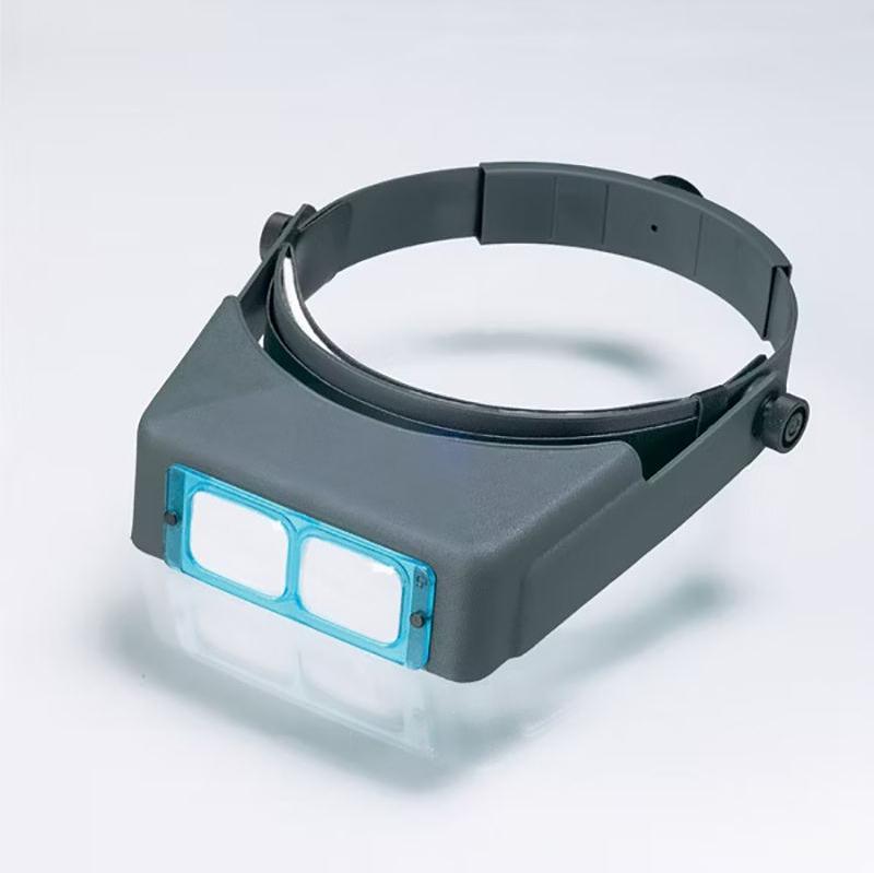 Professional Optivisor head-worn magnifier with adjustable headband and dual glass lenses for hands-free precision work.