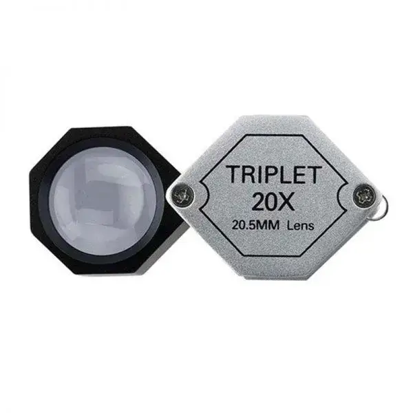 Hexagon-shaped 20x magnification triplet loupe with a 20.5mm lens and a textured silver folding cover.