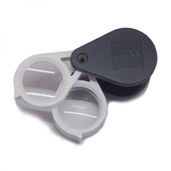Zeiss D40 aplanatic-achromatic 10x jewelry loupe with a white lens frame and black protective folding cover.
