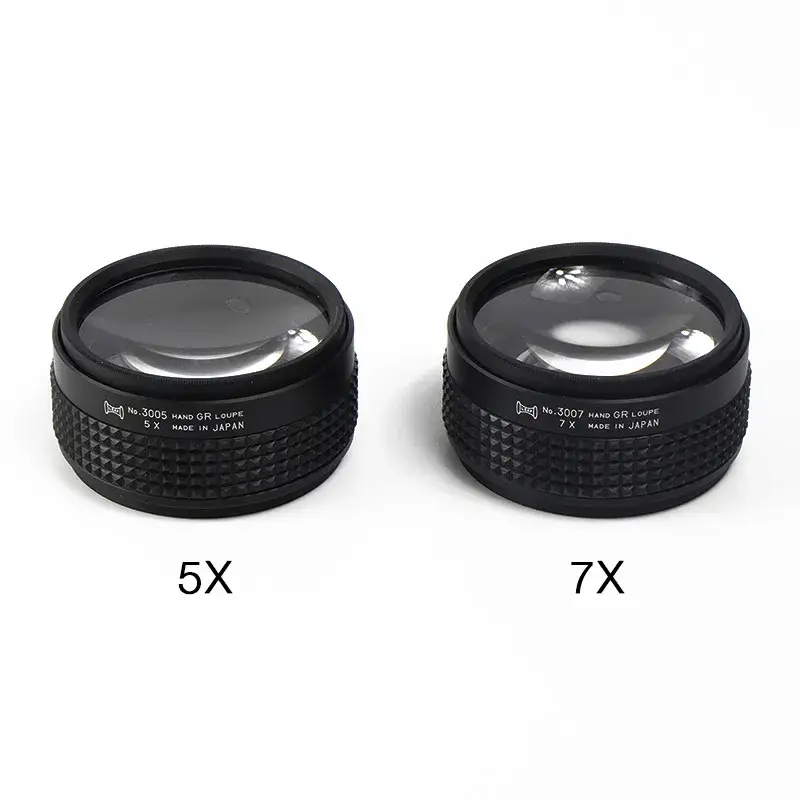 Two Alfa Mirage hand grip loupe magnifiers displaying 5x and 7x magnification options side by side.