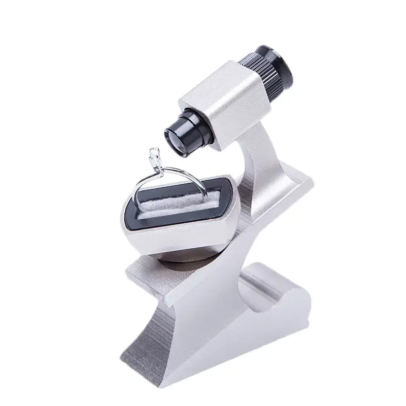 Specialized diamond inscription viewer loupe on a metal stand inspecting a diamond ring.
