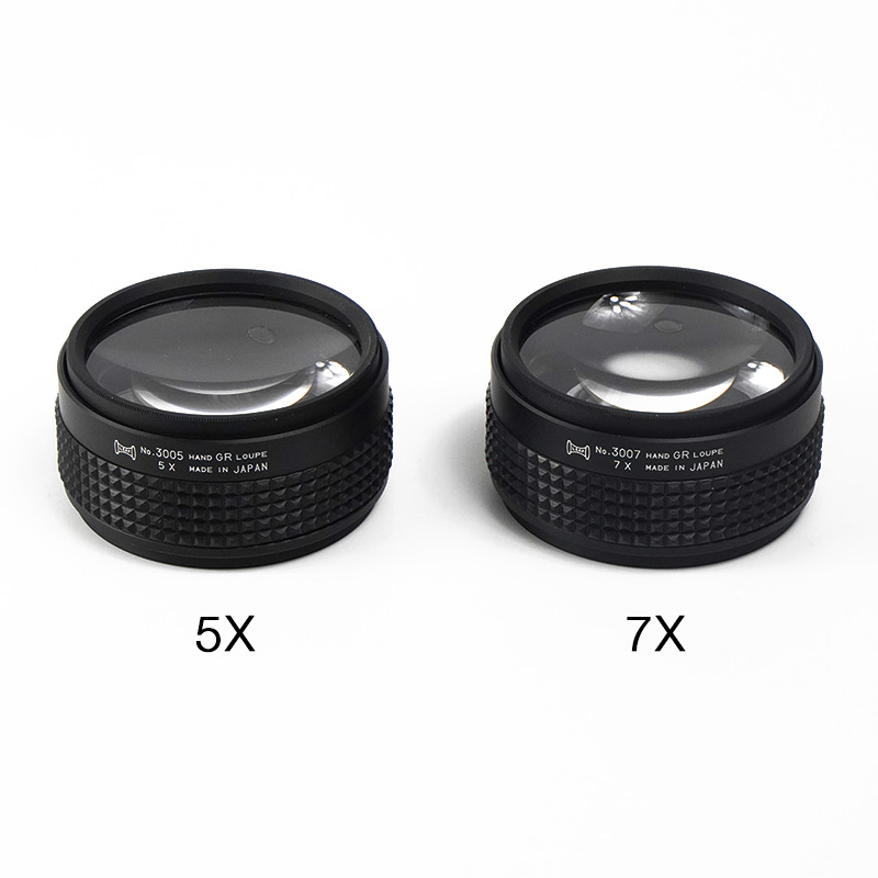 Japanese-made 5x and 7x hand-grip loupes with textured non-slip bodies for steady jewelry stone setting.