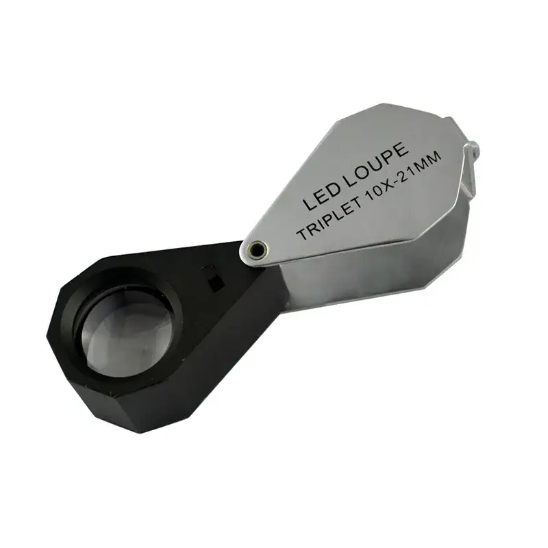 A silver and black folding triplet loupe magnifier with 10x-21mm specification text and a built-in LED light.
