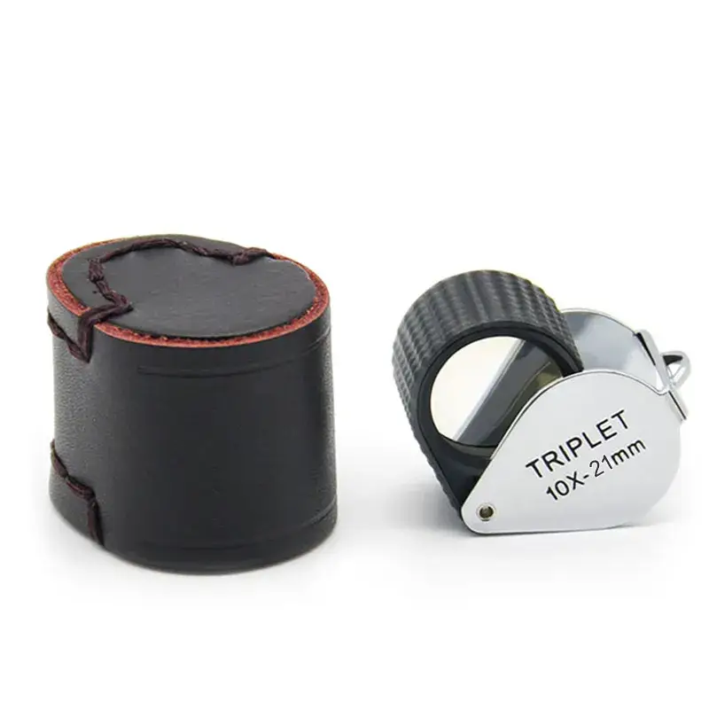 A 10X-21mm triplet loupe with a textured black rubber grip next to its small black leather carrying case.
