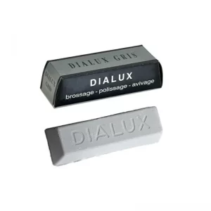 The authentic DIALUX Grey (Gris) 5 oz polishing compound bar shown resting in front of its signature grey and black cardboard packaging box.