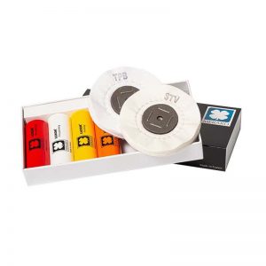 The LUXOR MERARD polishing kit displayed inside its open white presentation box showcasing four $120\text{g}$ compound bars alongside TPB and STV cotton buffs.