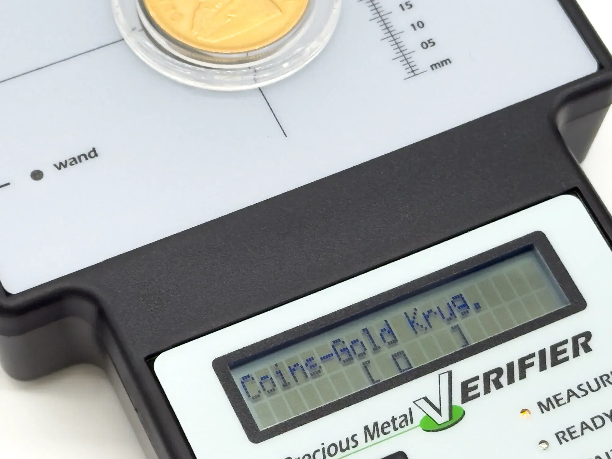 sigma metalytics precious metal verifier pmv original Close-up display of a slabbed gold Krugerrand coin undergoing sub-surface testing with target alignment brackets visible on the LCD.