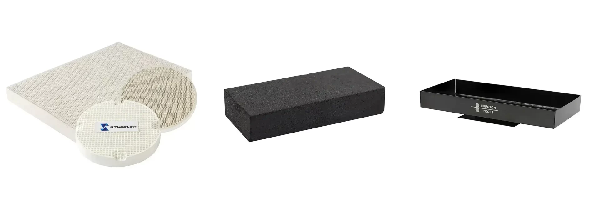 A collection of soldering surfaces: a honeycomb solder board, a charcoal block, and a Durston annealing pan.