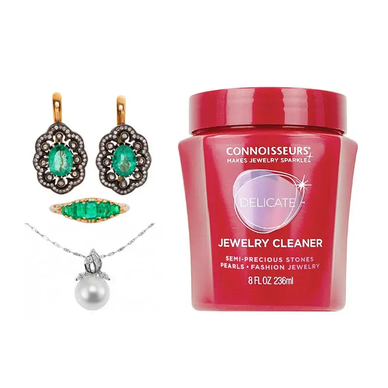 Connoisseurs delicate jewelry cleaner with emerald earrings and pearl pendant.