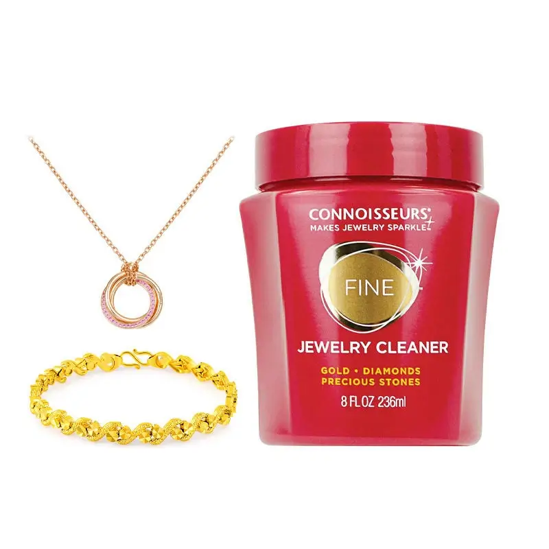 Connoisseurs fine jewelry cleaner jar with gold pendant necklace and bracelet.