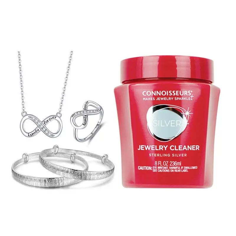 Connoisseurs silver jewelry cleaner dip jar with sterling silver rings and bangles.