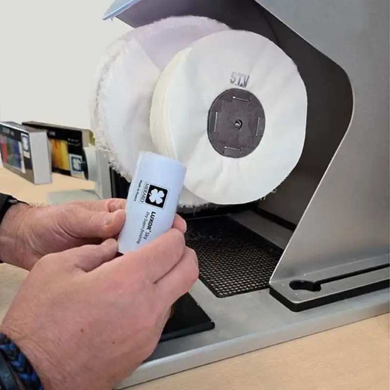 luxor® merard sky solid cylindrical polishing paste Applying LUXOR Sky polishing compound to a rotating STV cotton buffing wheel on a bench motor.