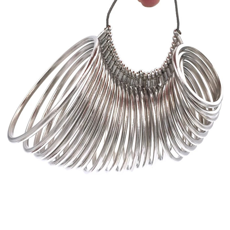 Full bundle of circular metal ring sizing gauges on a steel wire loop.