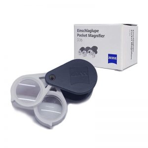Zeiss D36 9x pocket loupe, open with two lenses visible, next to its retail box.