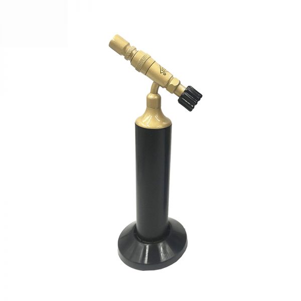 A black and gold butane torch is shown upright on its round base, isolated against a white background.