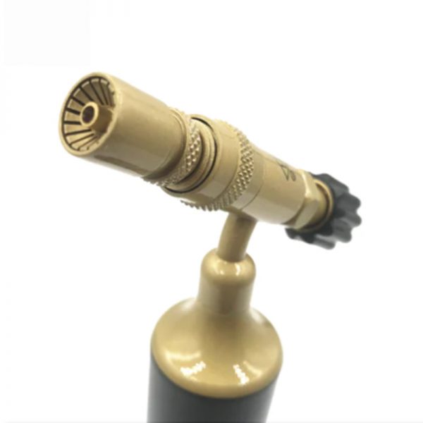 A detailed, close-up shot of the butane torch's nozzle, highlighting its ridged texture and gas outlets.