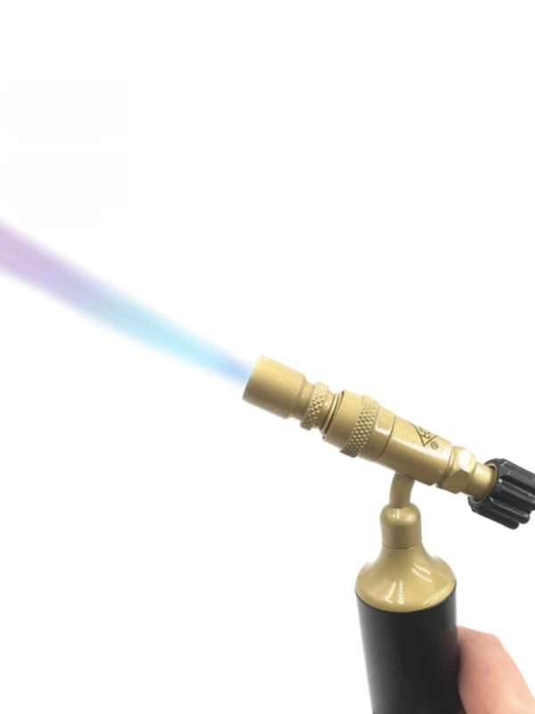 A hand holds a lit butane torch, with a strong blue flame shooting from the nozzle against a clean, white background.