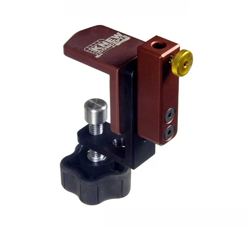 a knew concepts mini bench clamp made of reddish brown metal and black plastic