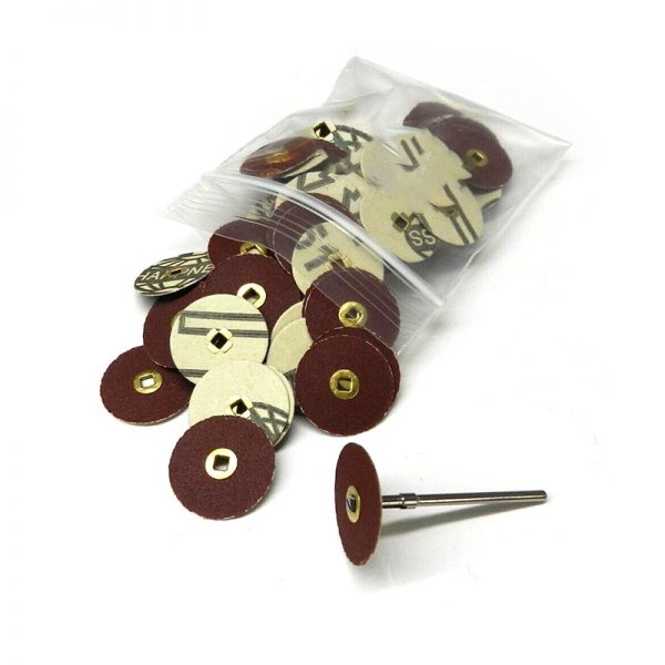 A clear bag of 22mm premium aluminum oxide sanding discs with brass centers with a few discs and a rotary mandrel beside it