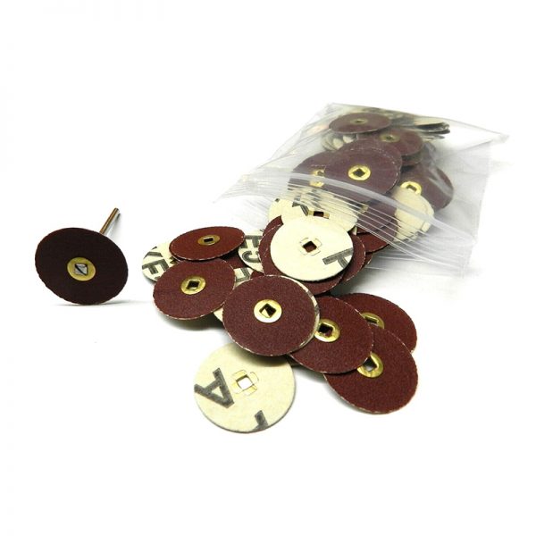 A clear bag of 22mm premium aluminum oxide sanding discs with brass centers with some spilled out alongside a rotary mandrel