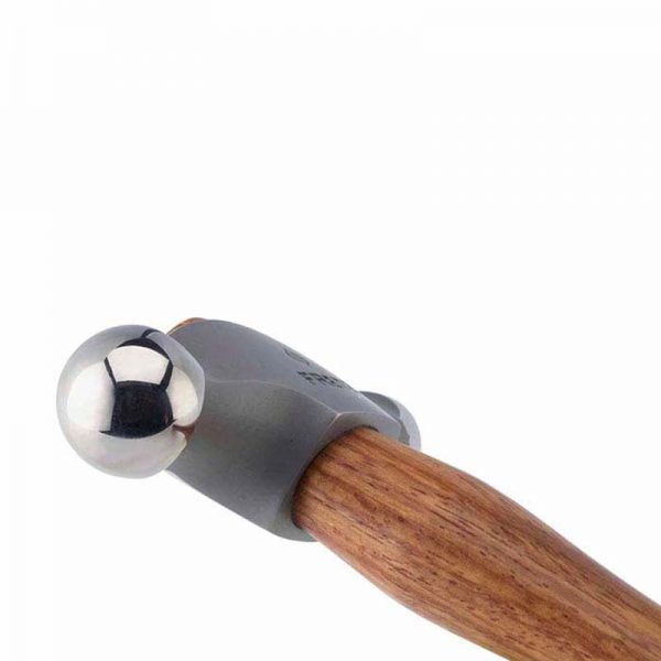 side close up of the fretz large embossing hammer highlighting its polished domed face and wooden handle for metal shaping