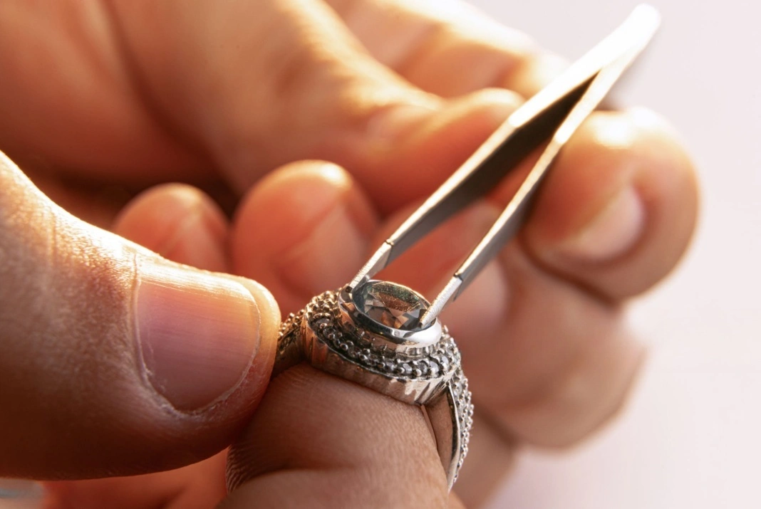 using tweezers to set a diamond in a ring