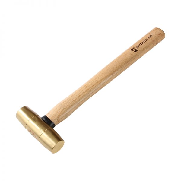 A Stuccler jeweler's brass mallet with a golden head and a light wooden handle, presented at an angle