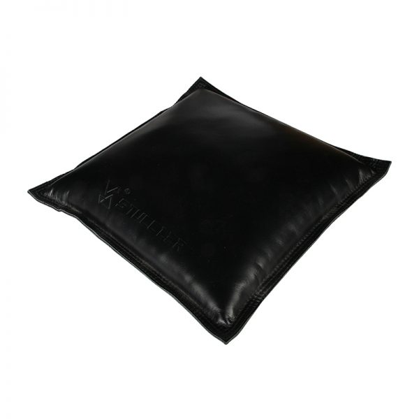 A close-up of a single square black jeweler's sandbag