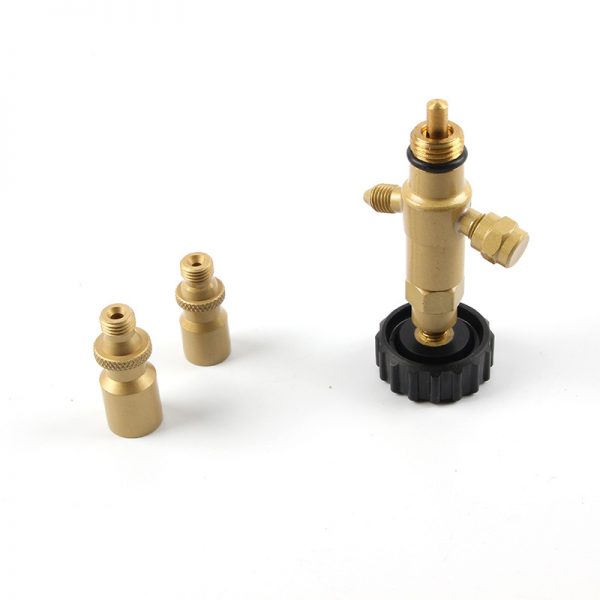 A close-up of the ORCA M75 CRD torch regulator and two interchangeable nozzles against a white background
