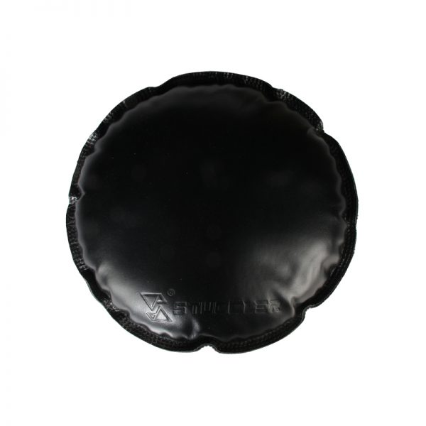 A close-up top-down view of a single round black jeweler's sandbag