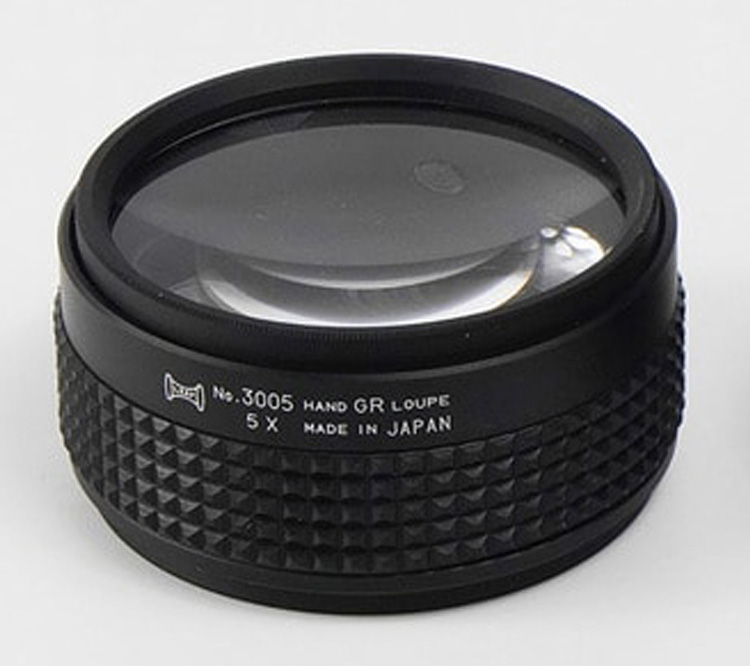 A close-up view of the black 5X Hand Grip Loupe, showing the "5 X" and "MADE IN JAPAN" text on the side