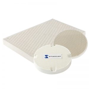 A collection of Stuccler honeycomb quartz soldering tiles in various shapes, including round, square, and rectangular