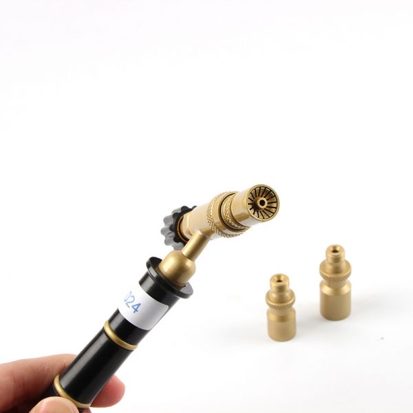 A hand holding the ORCA M75 torch, with one nozzle attached and the other two nozzles visible in the background