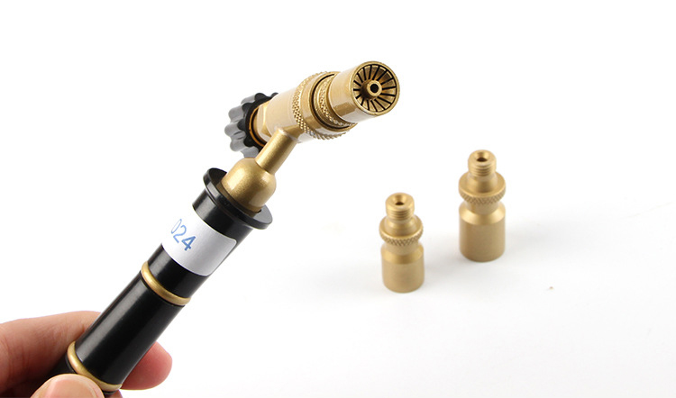 A hand holds the ORCA M75 torch with one nozzle attached and two others nearby