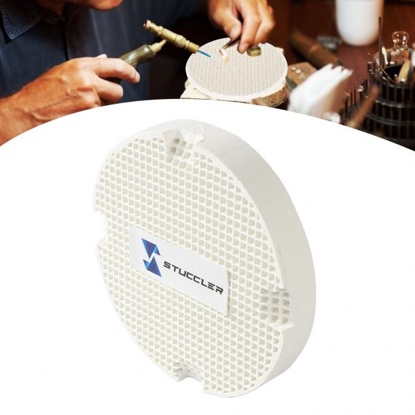 A jeweler uses a torch on a Stuccler honeycomb soldering tile, with another tile in the foreground
