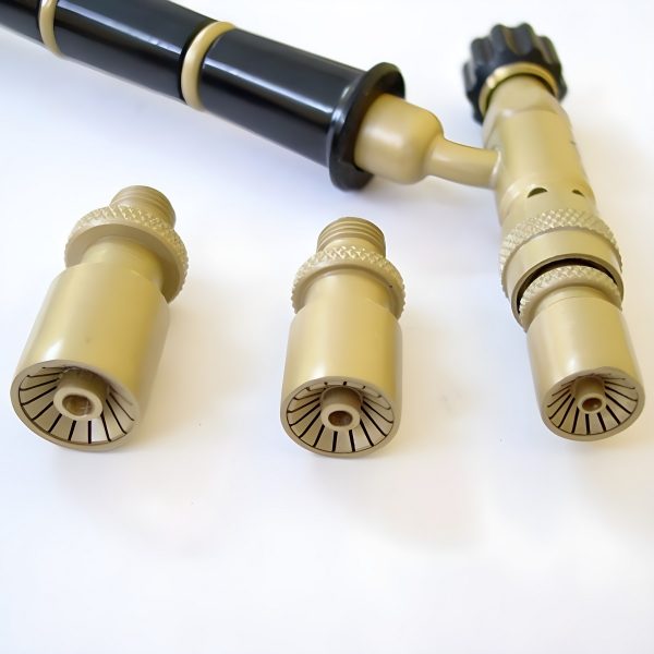 A lower angle view of the assembled torch handle with one nozzle attached, alongside the other two detached nozzles