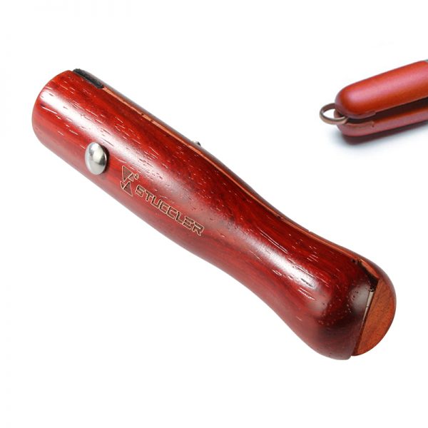 Close-up of a Stuccler® ring clamp, showing the wooden wedge inserted to secure a ring for polishing or setting