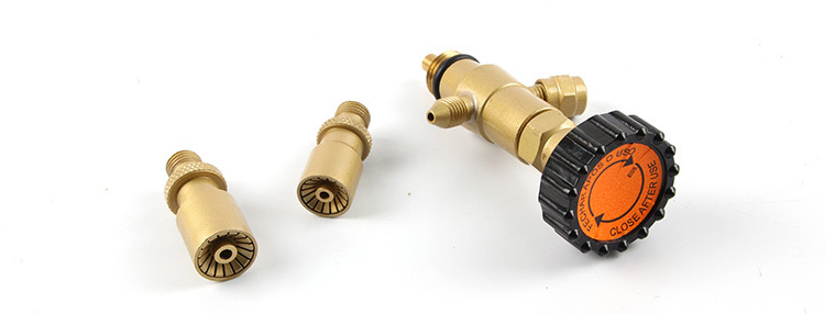 Close-up of the three interchangeable nozzles and gas pressure regulator from the ORCA M75 CRD kit, highlighting the knob and connectors