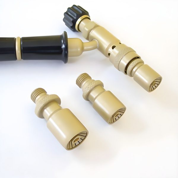 Close-up of the torch handle and the three nozzles from another perspective, highlighting their threaded connections and knurled grips
