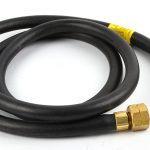 Coiled ORCA M125TF hose with brass fittings, showcasing the quick-connect ends